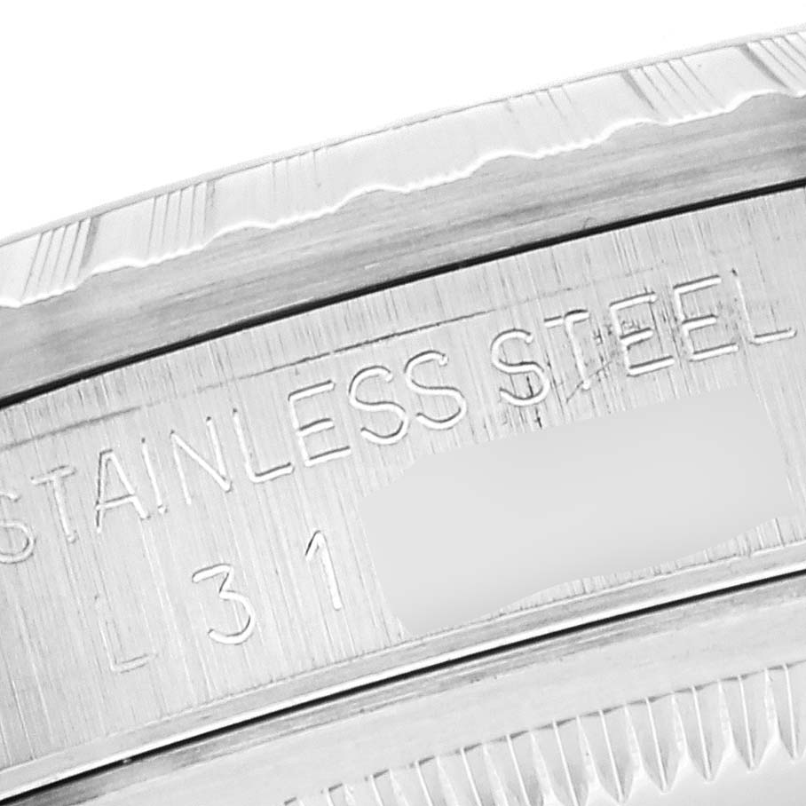 This image shows a close-up of the engraved side of a stainless steel Rolex Datejust 16220 Men's Stainless Steel Silver Dial 16220 Men's Stainless Steel Silver Dial watch case.