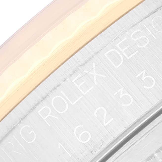 This close-up shows the engraved bezel of the Rolex Datejust 16233 Men's Steel and Gold (two tone) White Dial 16233 Men's Steel and Gold (two tone) White Dial watch, featuring its model inscription.