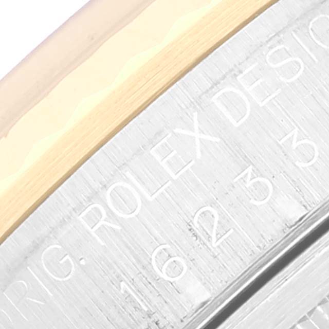 The image shows an angled close-up view of the engraved side of the case for a Rolex Datejust 16233 Men's Steel and Gold (two tone) Champagne Dial 16233 Men's Steel and Gold (two tone) Champagne Dial watch.