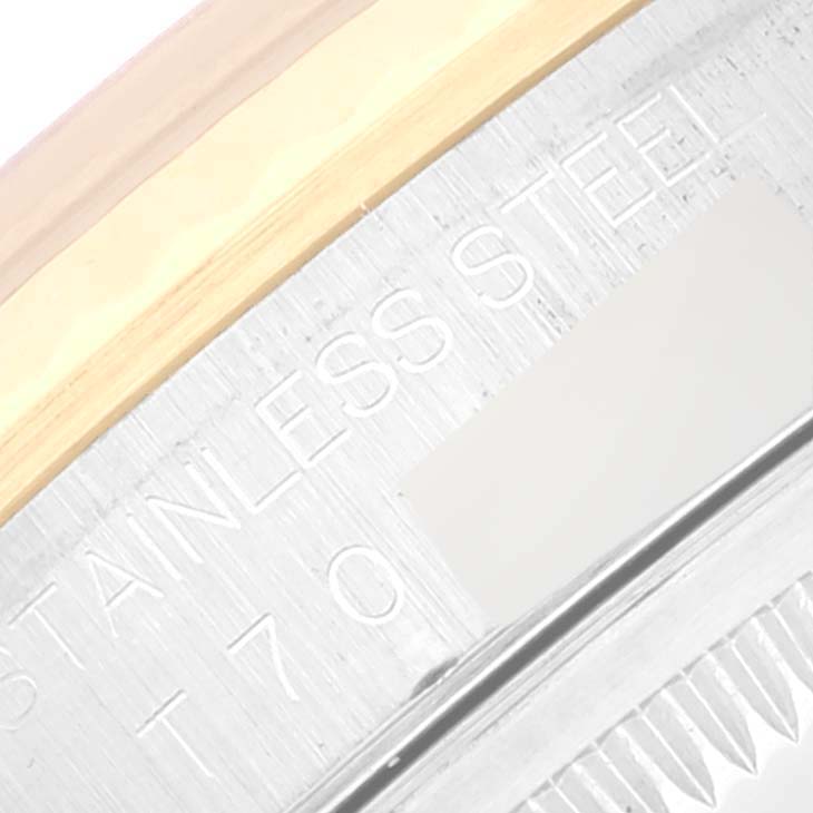 The image shows a close-up of the bezel and part of the caseback of a Rolex Datejust 16233 Men's Steel and Gold (two tone) Champagne Dial 16233 Men's Steel and Gold (two tone) Champagne Dial watch, highlighting the "Stainless Steel" engraving.