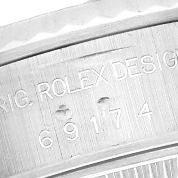 This close-up shows the engraved serial and model number on the side of the Datejust Rolex watch case.