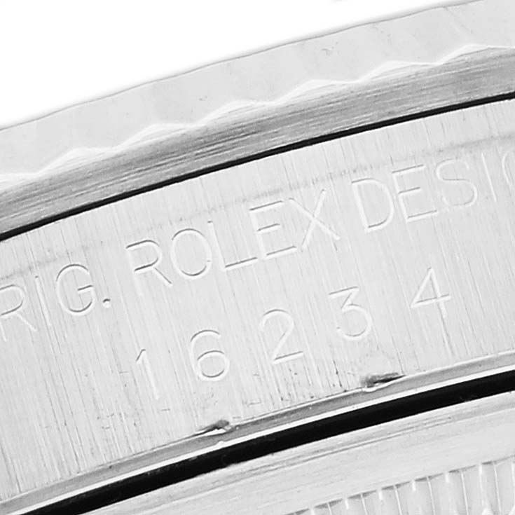 The image shows a close-up of the engraved inner bezel of a Rolex Datejust 16234 Men's Stainless Steel Blue Dial 16234 Men's Stainless Steel Blue Dial model.