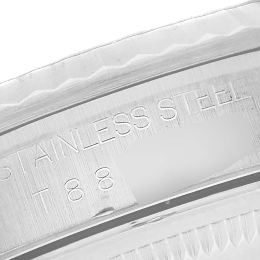 The image shows a close-up of the side edge of a Rolex Datejust 16234 Men's Stainless Steel Blue Dial 16234 Men's Stainless Steel Blue Dial watch bezel and part of the engraved stainless steel marking.