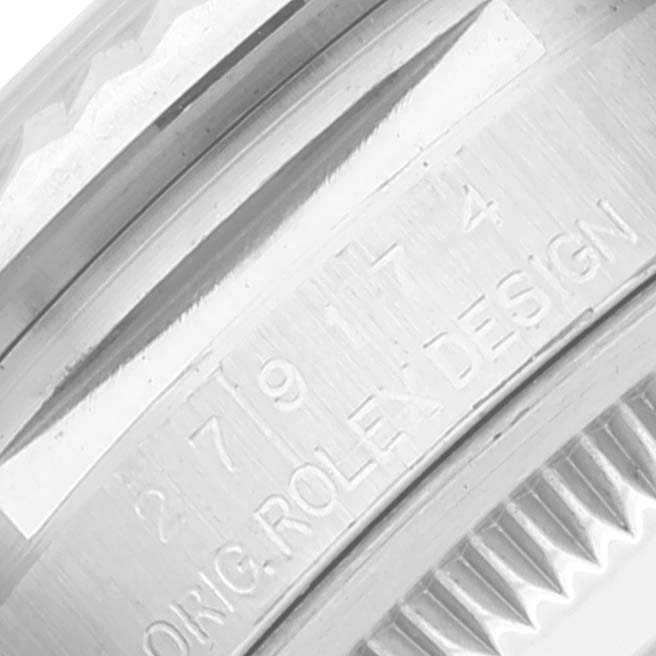 This close-up shows the engraved serial number and "ORIG ROLEX DESIGN" on the side of the case of a Rolex Datejust 279174 Women
s Stainless Steel Mother of Pearl Dial 279174 Women
s Stainless Steel Mother of Pearl Dial watch.