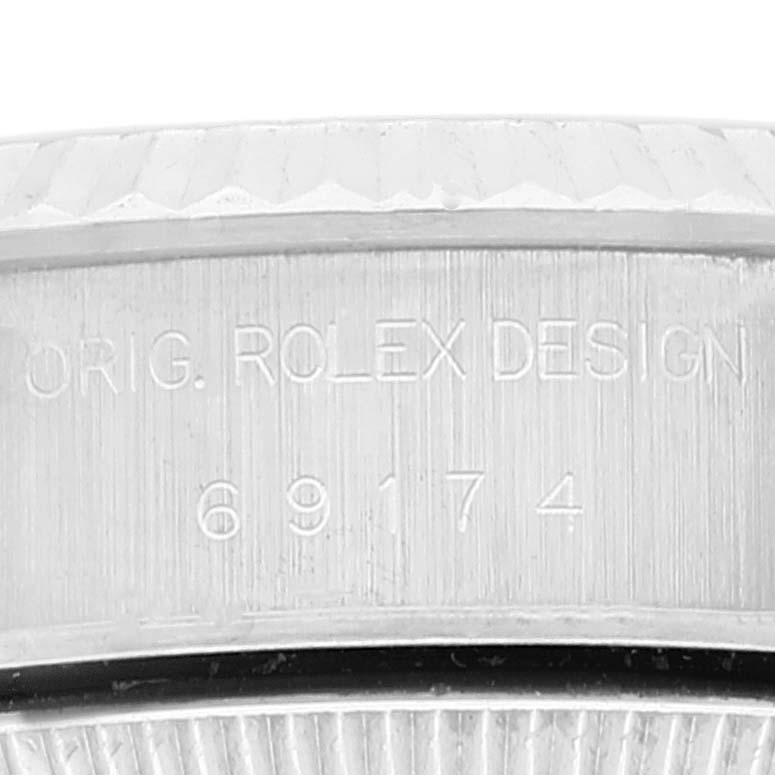 This is a close-up view of the serial number and design engraving on a Rolex Datejust 69174 Women's Stainless Steel Pink Dial 69174 Women's Stainless Steel Pink Dial watch case.