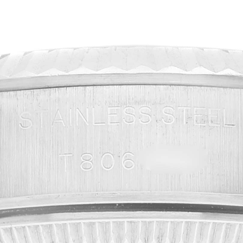 The image shows a close-up of the case side of a Rolex Datejust 69174 Women's Stainless Steel Pink Dial 69174 Women's Stainless Steel Pink Dial watch, highlighting the "Stainless Steel" engraving.