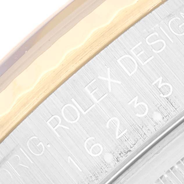 This close-up image shows the engraved text on the side of the Rolex Datejust 16233 Men's Steel and Gold (two tone) Black Dial 16233 Men's Steel and Gold (two tone) Black Dial watch bezel.