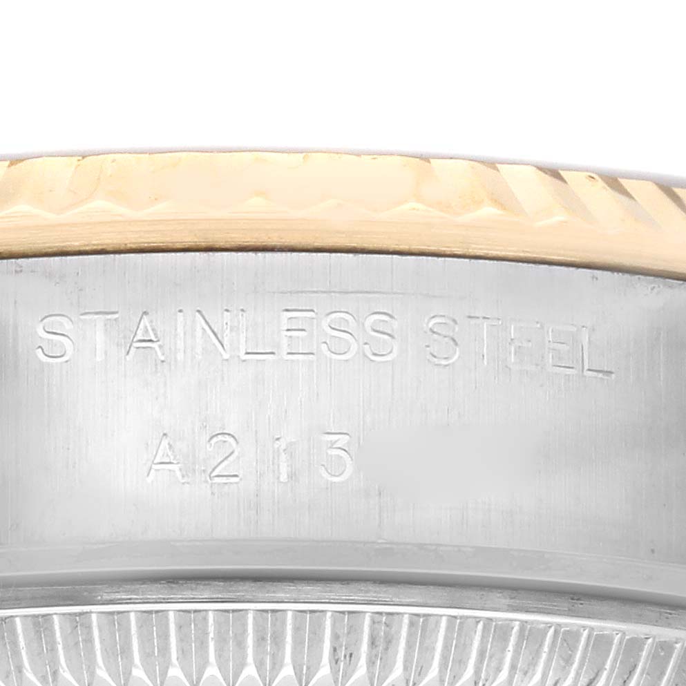 This image shows the side view of the bezel and case of a Rolex Datejust 79173 Women's Steel and Gold (two tone) Champagne Dial 79173 Women's Steel and Gold (two tone) Champagne Dial watch, highlighting the “STAINLESS STEEL” engraving.