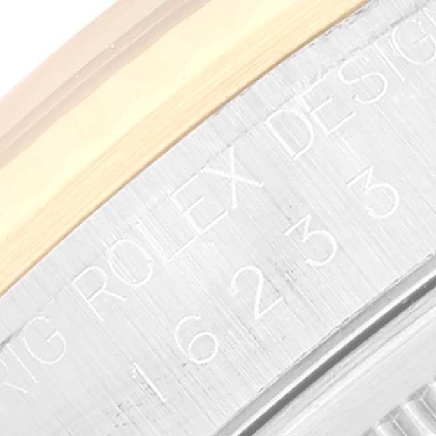 The image shows a close-up of the side casing of a Rolex Datejust 16233 Men's Steel and Gold (two tone) Champagne Dial 16233 Men's Steel and Gold (two tone) Champagne Dial watch with engraved text.