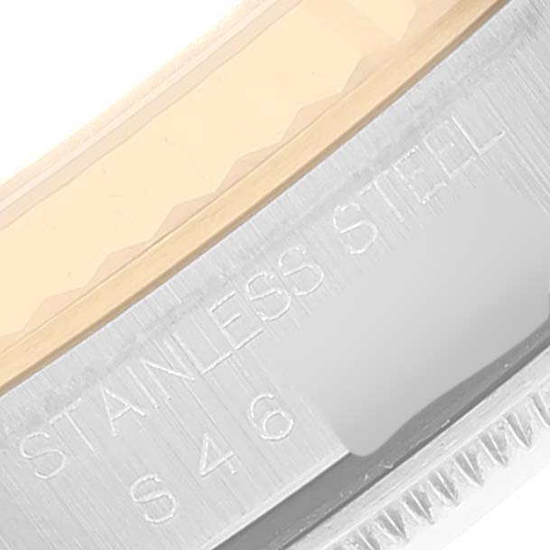 The image shows a detailed close-up of the side of a Rolex Datejust 16233 Men's Steel and Gold (two tone) Champagne Dial 16233 Men's Steel and Gold (two tone) Champagne Dial watch, revealing the stainless steel engraving.