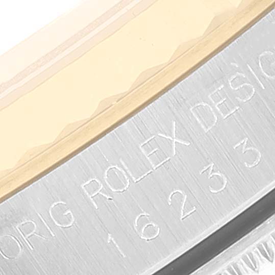 This close-up shows the engraved edge and part of the bezel of the Rolex Datejust 16233 Men's Steel and Gold (two tone) Champagne Dial 16233 Men's Steel and Gold (two tone) Champagne Dial watch.