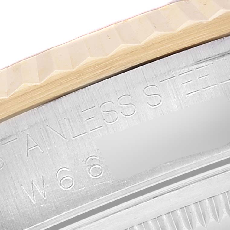 The image shows a close-up angle of the fluted bezel and part of the case back of a Rolex Datejust 16233 Men's Steel and Gold (two tone) Champagne Dial 16233 Men's Steel and Gold (two tone) Champagne Dial.