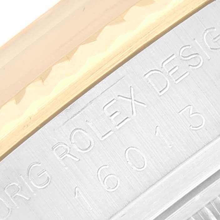 The image shows a close-up of the side engraving and part of the bezel on a Rolex Datejust 16013 Men's Steel and Gold (two tone) Champagne Dial 16013 Men's Steel and Gold (two tone) Champagne Dial watch.