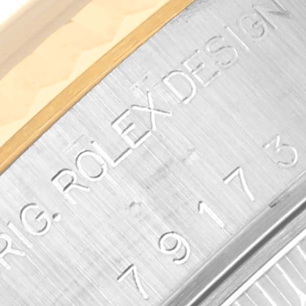 Close-up view of the engraved side of a Rolex Datejust 79173 Women's Steel and Gold (two tone) Blue Dial 79173 Women's Steel and Gold (two tone) Blue Dial watch casing.