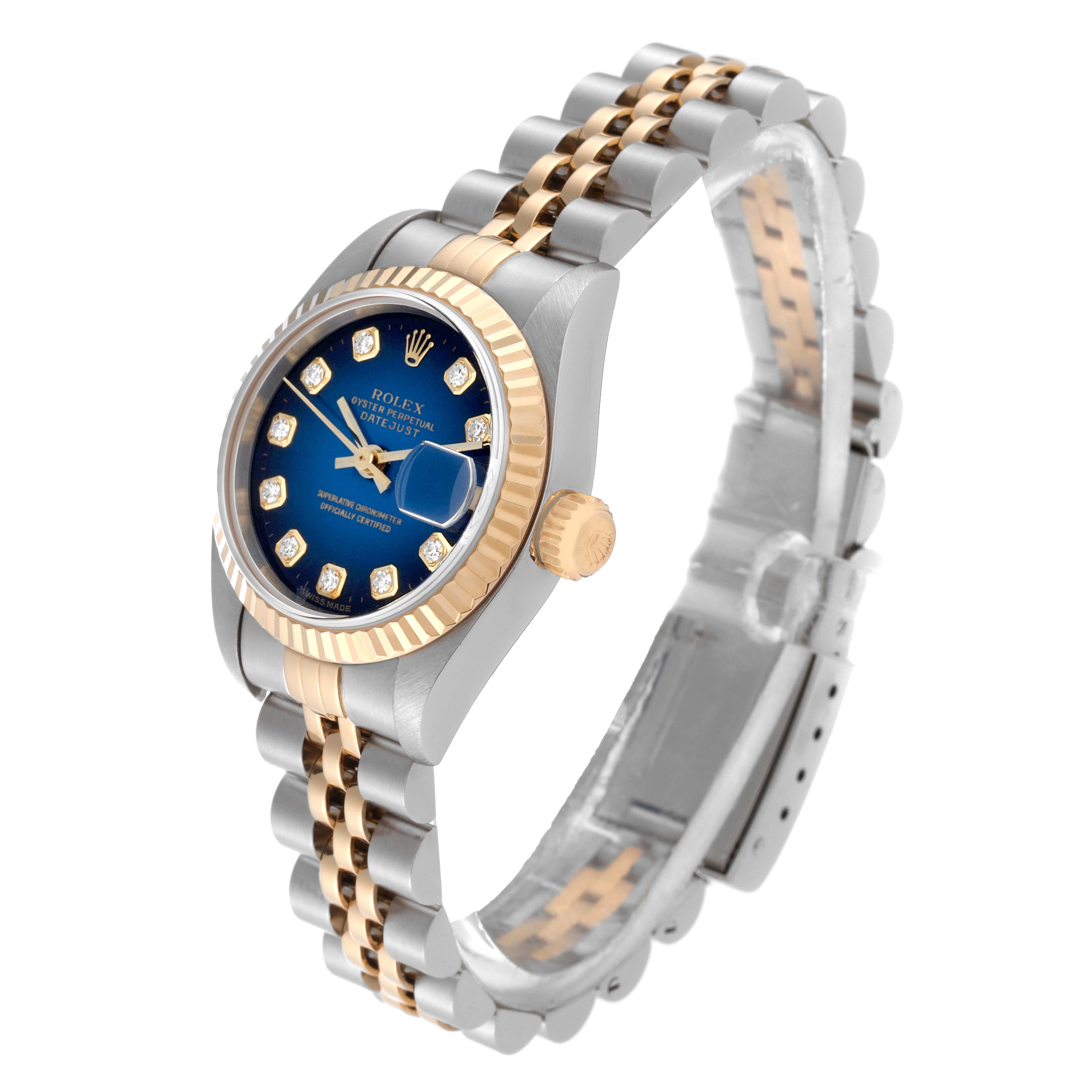The Rolex Datejust 79173 Women's Steel and Gold (two tone) Blue Dial 79173 Women's Steel and Gold (two tone) Blue Dial watch is angled to show its blue dial, fluted bezel, gold crown, and two-tone bracelet.