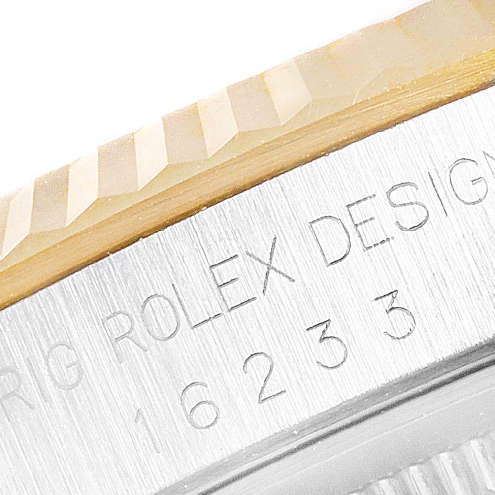 This image shows a close-up of the bezel and part of the case side of a Rolex Datejust 16233 Men's Steel and Gold (two tone) White Dial 16233 Men's Steel and Gold (two tone) White Dial model.