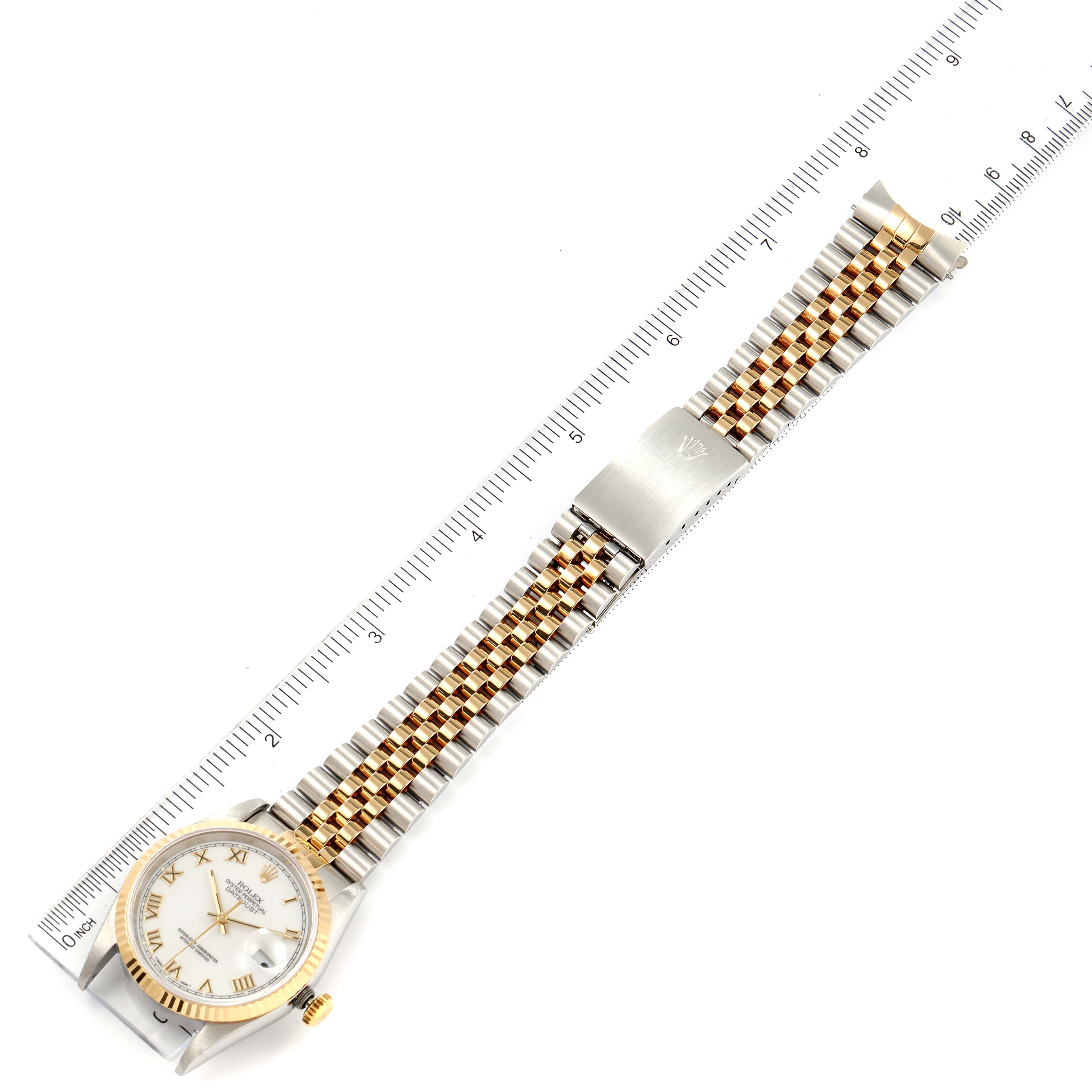 The image shows a Rolex Datejust 16233 Men's Steel and Gold (two tone) White Dial 16233 Men's Steel and Gold (two tone) White Dial watch laid flat, displaying its face, crown, case, and full bracelet alongside a ruler for measurement.