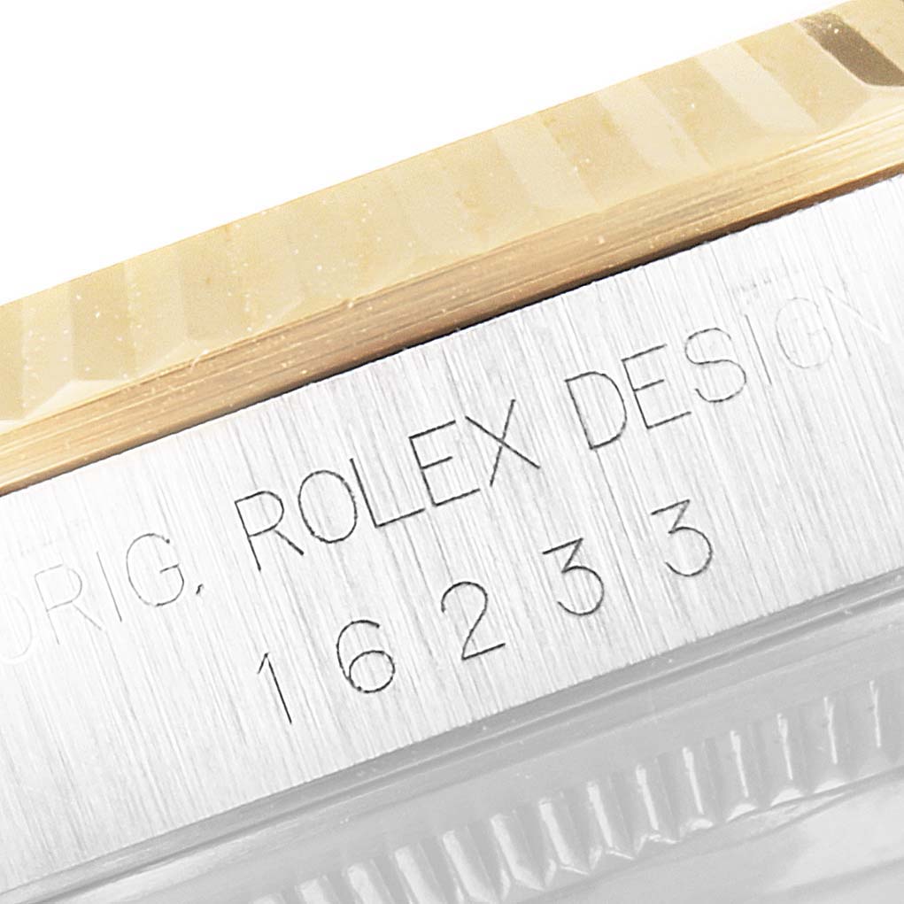 This image shows a close-up of the bezel and case engraving of a Rolex Datejust 16233 Men's Steel and Gold (two tone) White Dial 16233 Men's Steel and Gold (two tone) White Dial watch.