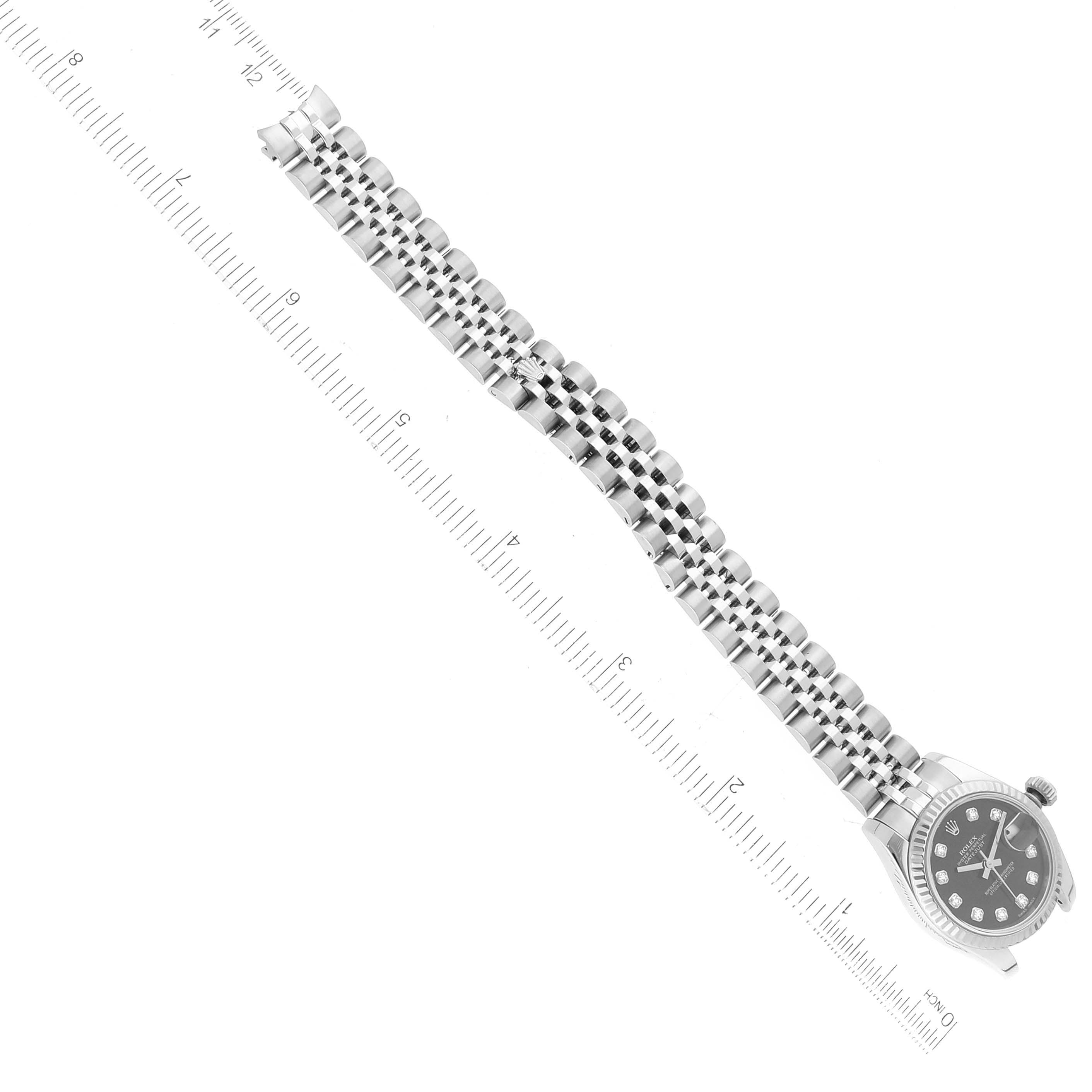 The image shows a top-view angle of a Rolex Datejust 179174 Women's Stainless Steel Black Dial 179174 Women's Stainless Steel Black Dial watch with a ruler next to it for size reference.