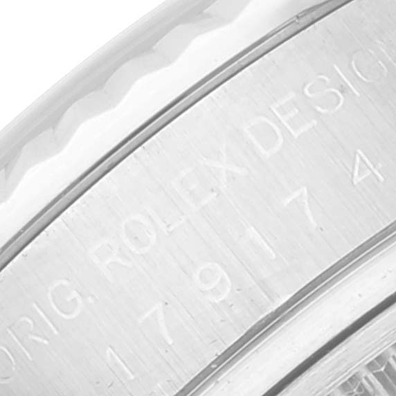 This image shows a close-up of the engraved bezel of a Rolex Datejust 179174 Women's Stainless Steel Black Dial 179174 Women's Stainless Steel Black Dial watch.