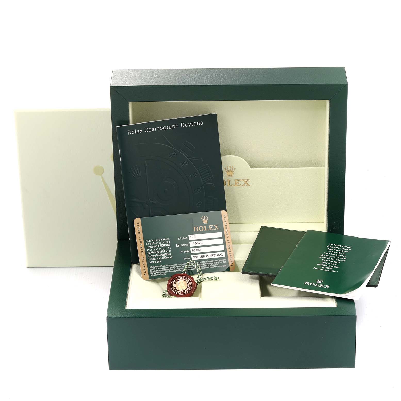 The image shows a Rolex Daytona 116520 Men
s Stainless Steel Black Dial 116520 Men
s Stainless Steel Black Dial watch box with accompanying booklets, a warranty card, and a hang tag, all arranged neatly.