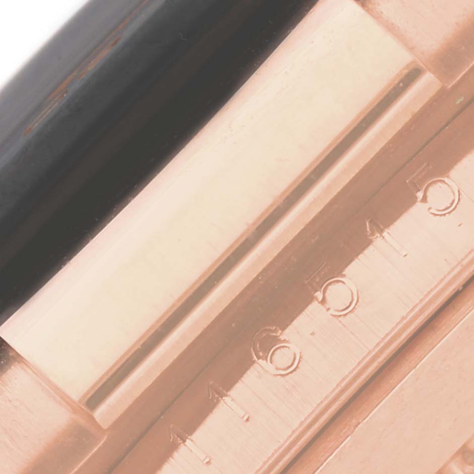 This image shows an extreme close-up of the edge of the bezel and part of the case of a Rolex Daytona 116515LN Men's Rose Gold Champagne Dial 116515LN Men's Rose Gold Champagne Dial watch.
