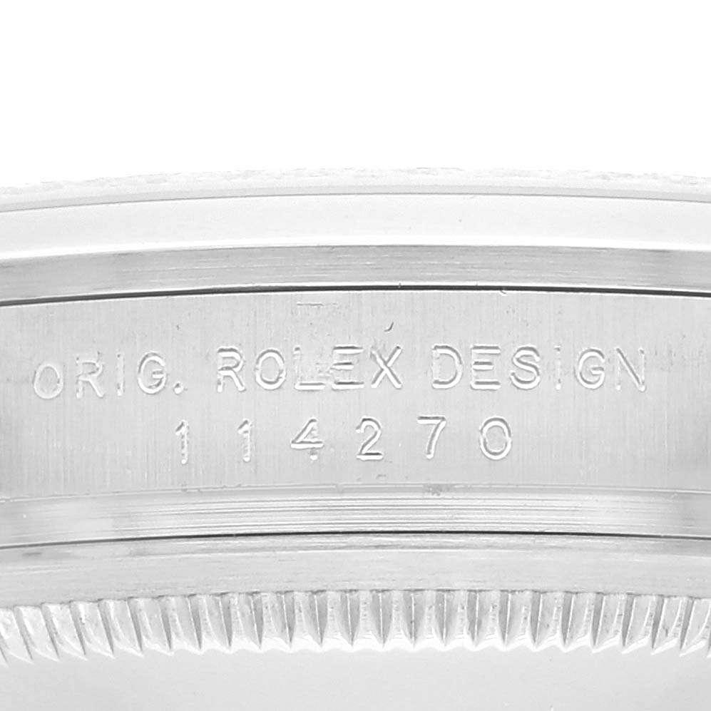 The image shows a close-up of the engraved case side of a Rolex Explorer 114270 Men's Stainless Steel Black Dial 114270 Men's Stainless Steel Black Dial watch, displaying the model number 114270.