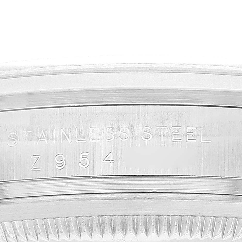 This image shows a close-up of the edge of a Rolex Explorer 114270 Men's Stainless Steel Black Dial 114270 Men's Stainless Steel Black Dial watch, highlighting the stainless steel and serial number.