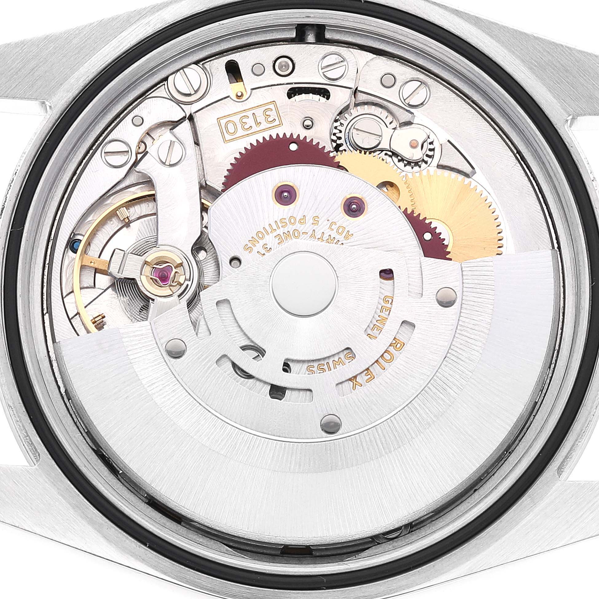 This image shows a close-up of the movement mechanism inside a Rolex Explorer 114270 Men's Stainless Steel Black Dial 114270 Men's Stainless Steel Black Dial watch, highlighting the gears and components.