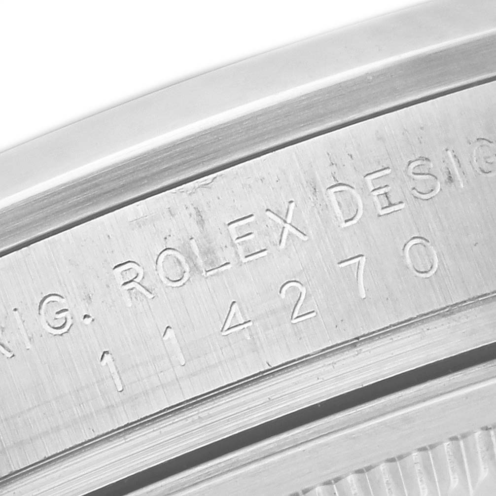 The image shows a close-up view of the engraved serial number and branding inside the case of a Rolex Explorer 114270 Men
s Stainless Steel Black Dial 114270 Men
s Stainless Steel Black Dial watch.