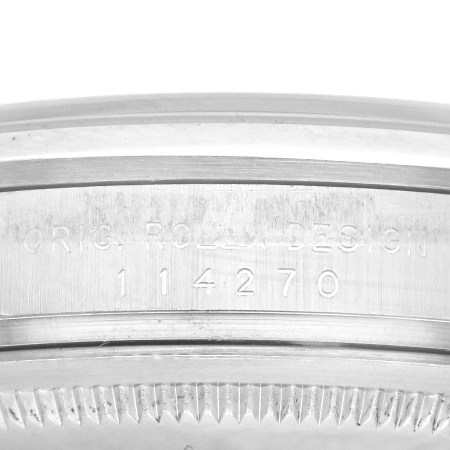 This image shows a close-up of the case back edge engravings on a Rolex Explorer 114270 Men
s Stainless Steel Black Dial 114270 Men
s Stainless Steel Black Dial watch.