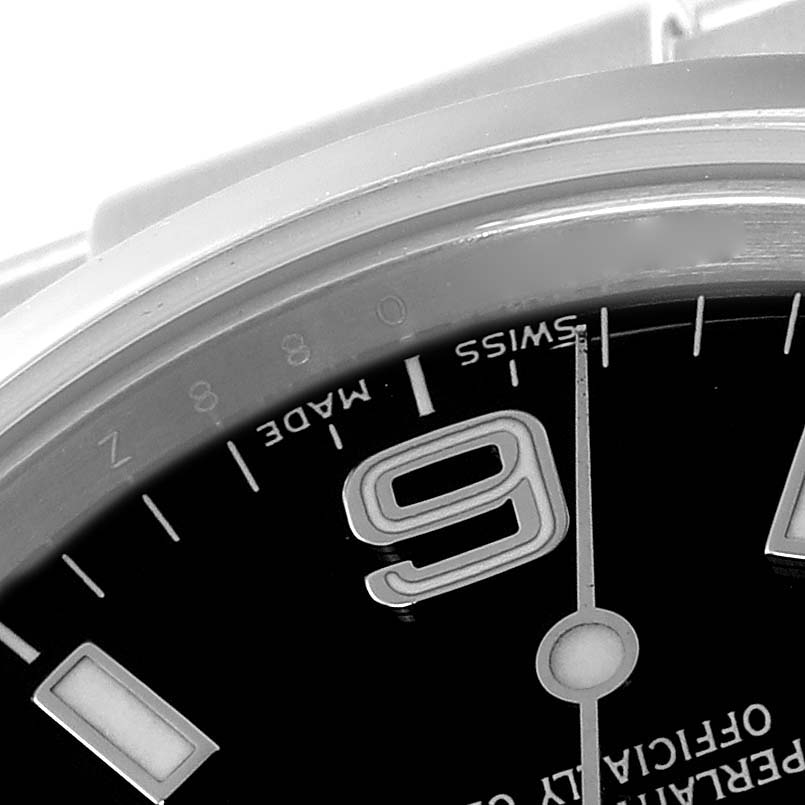 Close-up angle of a Rolex Explorer 114270 Men
s Stainless Steel Black Dial 114270 Men
s Stainless Steel Black Dial watch showing part of the dial, the "9" marker, minute hand, and the "Swiss Made" text.