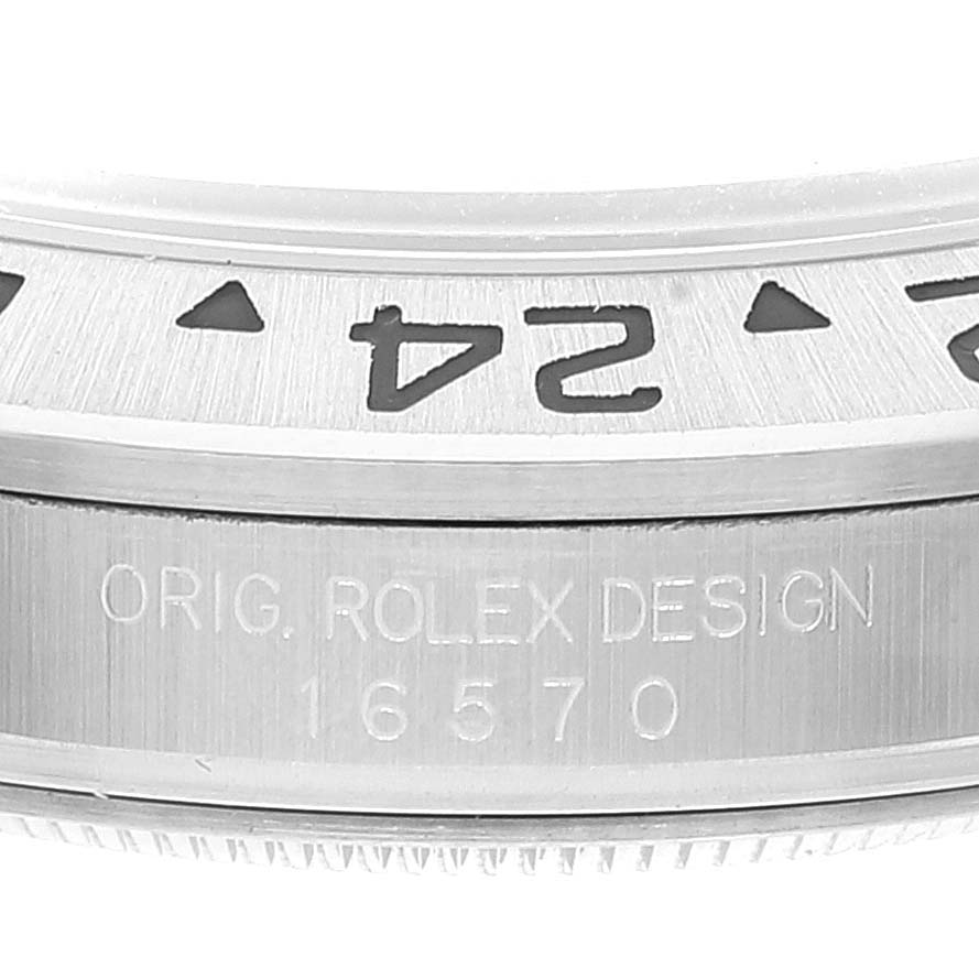 This image shows a close-up of the bezel and the serial engraving on the Rolex Explorer 16570 Men's Stainless Steel White Dial 16570 Men's Stainless Steel White Dial model 16570.