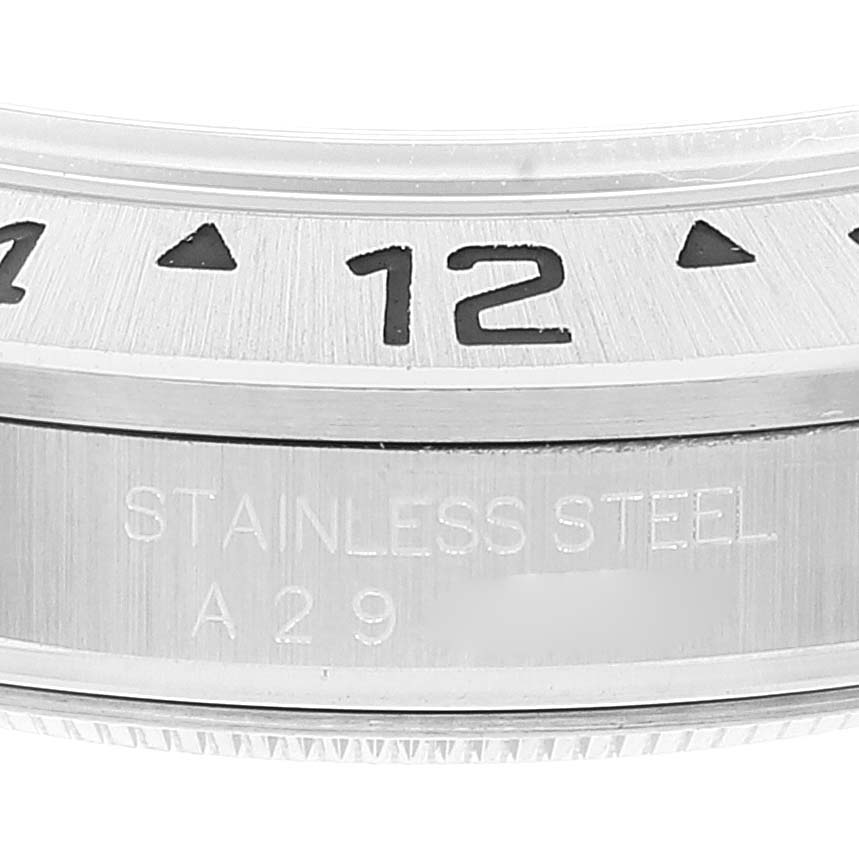 This image shows a close-up of the bezel and casing of the Rolex Explorer 16570 Men's Stainless Steel White Dial 16570 Men's Stainless Steel White Dial watch, highlighting the "12" marker and "Stainless Steel" inscription.