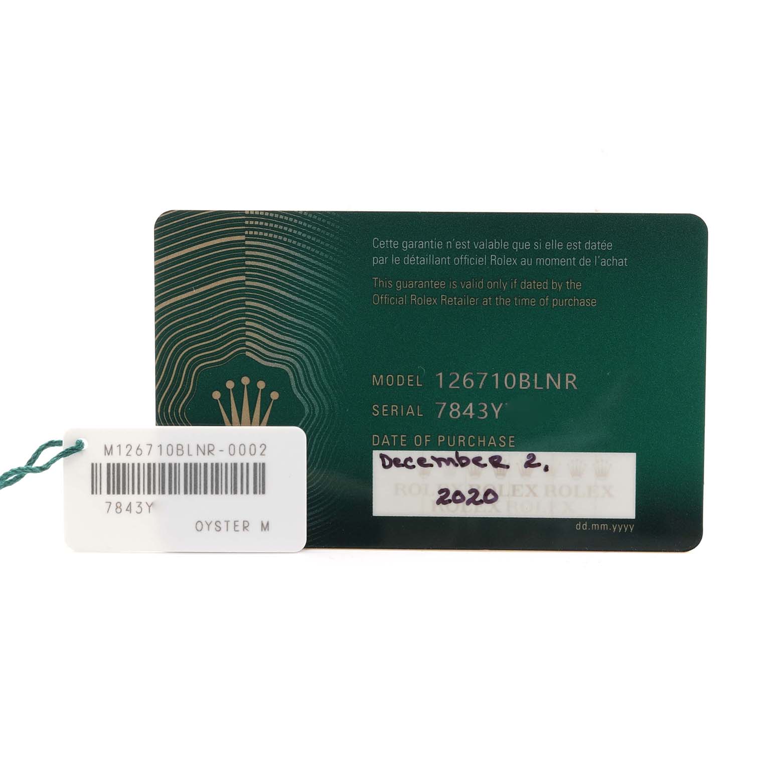 The image shows a warranty card and a tag for a Rolex GMT-Master 126710BLNR Men's Stainless Steel Black Dial 126710BLNR Men's Stainless Steel Black Dial model 126710BLNR watch, displaying the serial number and purchase date.