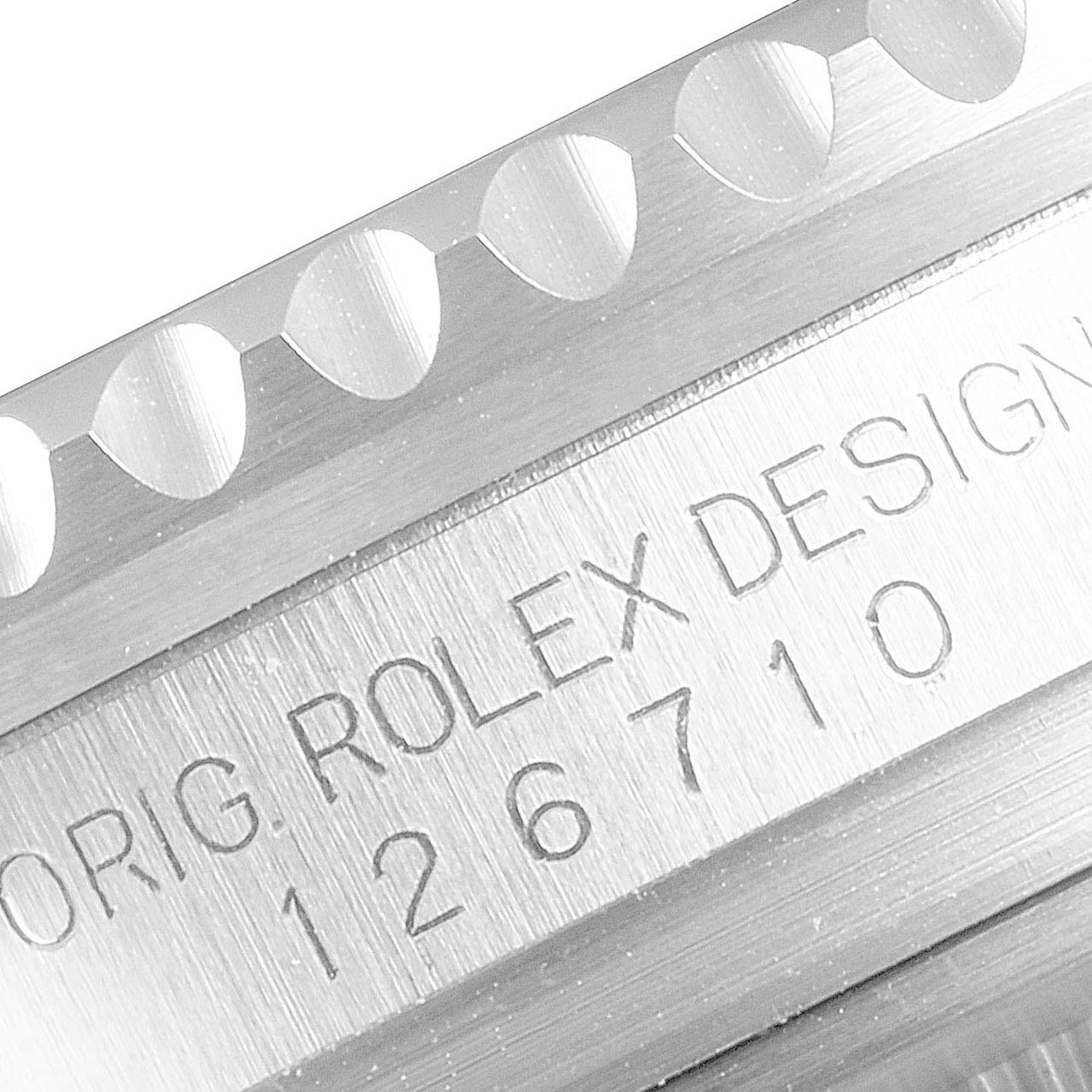 The image shows a close-up of the side of a Rolex GMT-Master 126710 Men
s Stainless Steel Black Dial 126710 Men
s Stainless Steel Black Dial watch, highlighting the reference number and part of the bezel.