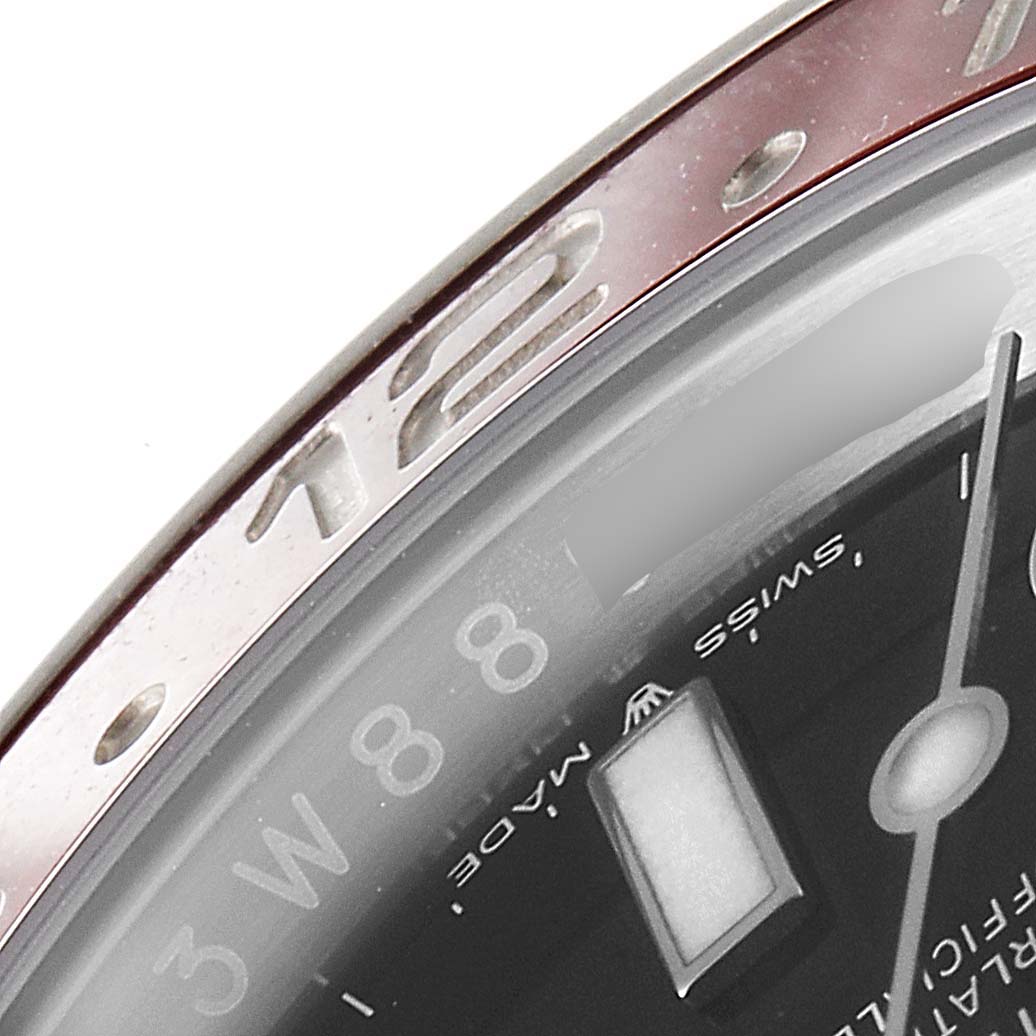 The image shows a close-up of the bezel and dial of a Rolex GMT-Master 126710 Men
s Stainless Steel Black Dial 126710 Men
s Stainless Steel Black Dial watch, highlighting the 12-hour marker and part of the dial.