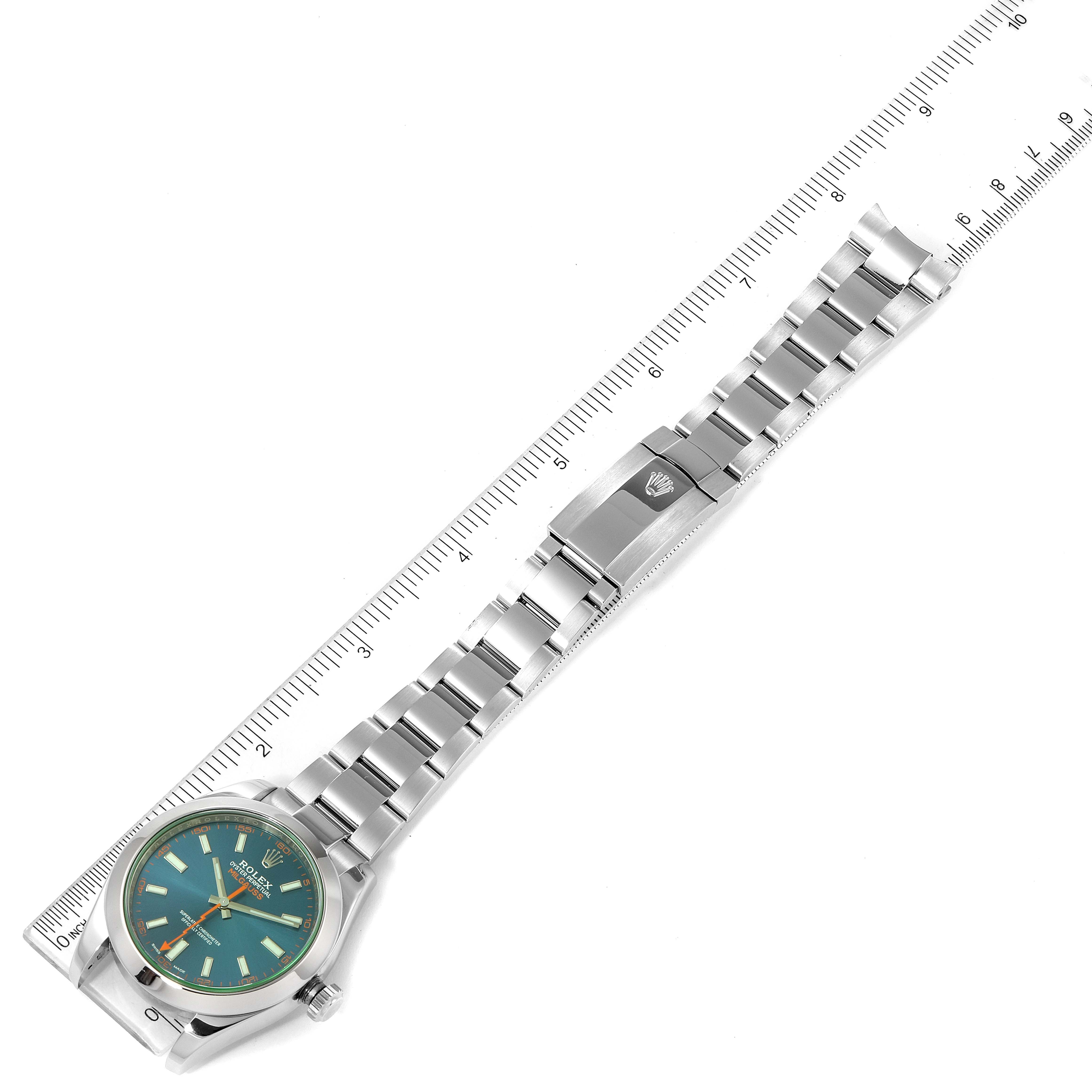 The image shows the Rolex Milgauss 116400GV Men
s Stainless Steel Blue Dial 116400GV Men
s Stainless Steel Blue Dial watch placed flat with an extended bracelet and a ruler alongside for measurement.