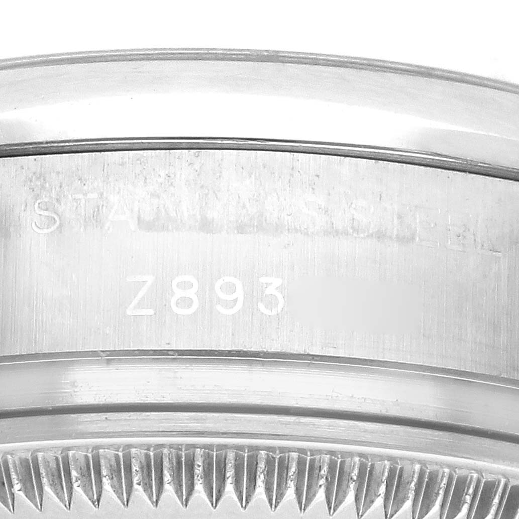 This image shows a close-up view of the side of the Rolex Oyster Perpetual 176200 Women's Stainless Steel Pink Dial 176200 Women's Stainless Steel Pink Dial watch, focusing on the case and part of the bezel.