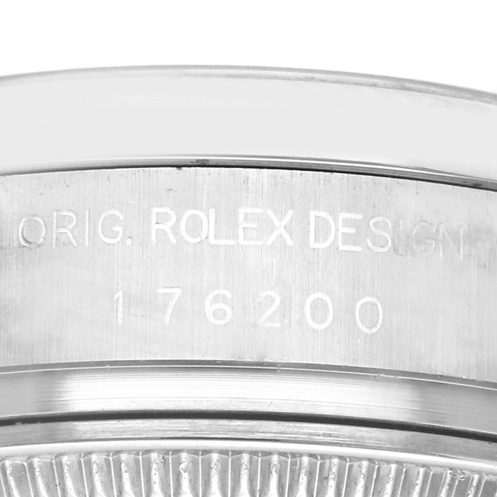 This image shows a close-up angle of the engraved case back of a Rolex Oyster Perpetual 176200 Women's Stainless Steel Pink Dial 176200 Women's Stainless Steel Pink Dial watch.