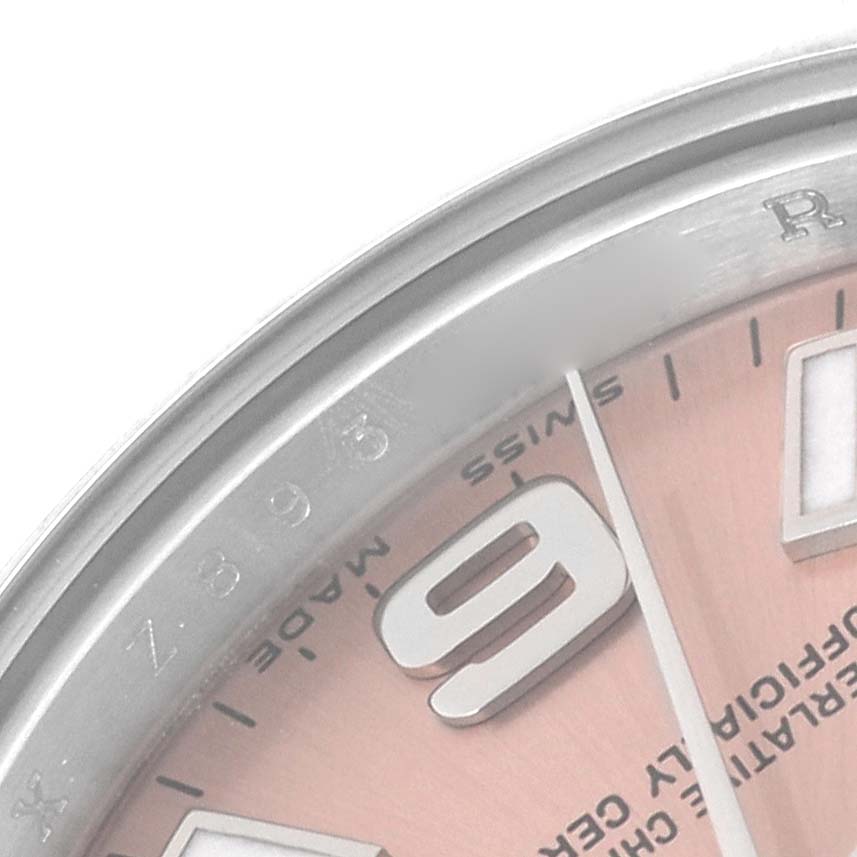 This close-up image shows the bezel, part of the dial, and hour markers of a Rolex Oyster Perpetual 176200 Women's Stainless Steel Pink Dial 176200 Women's Stainless Steel Pink Dial watch.