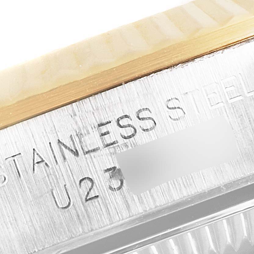 The image shows a close-up of the side of a Rolex Oyster Perpetual 67193 Women's Steel and Gold (two tone) Black Dial 67193 Women's Steel and Gold (two tone) Black Dial watch, focusing on the stainless steel and part of the serial number.