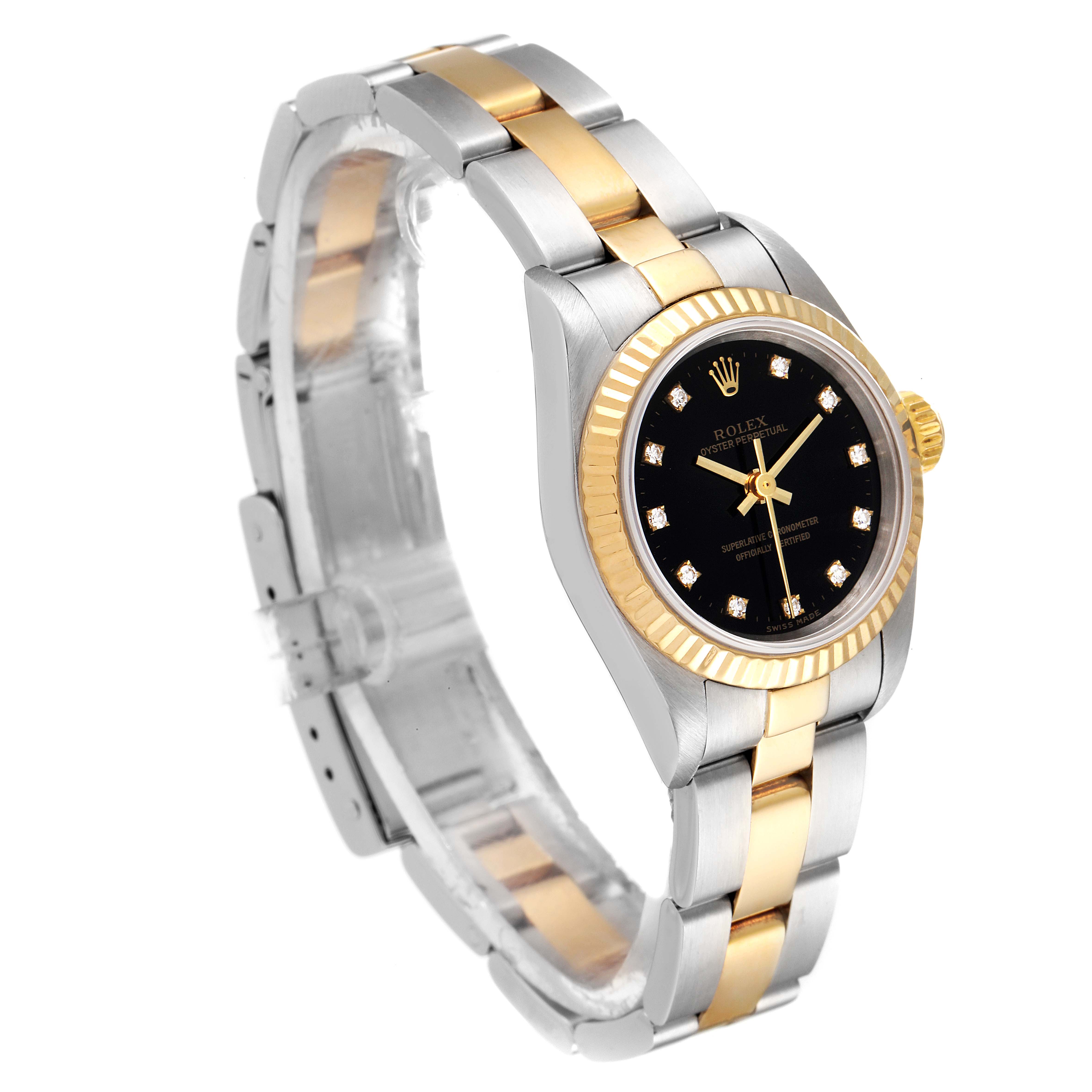 The image shows a Rolex Oyster Perpetual 67193 Women's Steel and Gold (two tone) Black Dial 67193 Women's Steel and Gold (two tone) Black Dial watch at a three-quarter angle, highlighting its black dial, gold bezel, and two-tone bracelet.