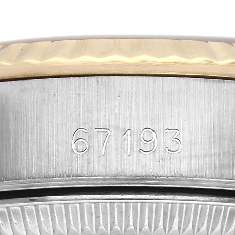 This image shows a close-up of the bezel and side of the case, including the serial number of a Rolex Oyster Perpetual 67193 Women's Steel and Gold (two tone) Champagne Dial 67193 Women's Steel and Gold (two tone) Champagne Dial watch.