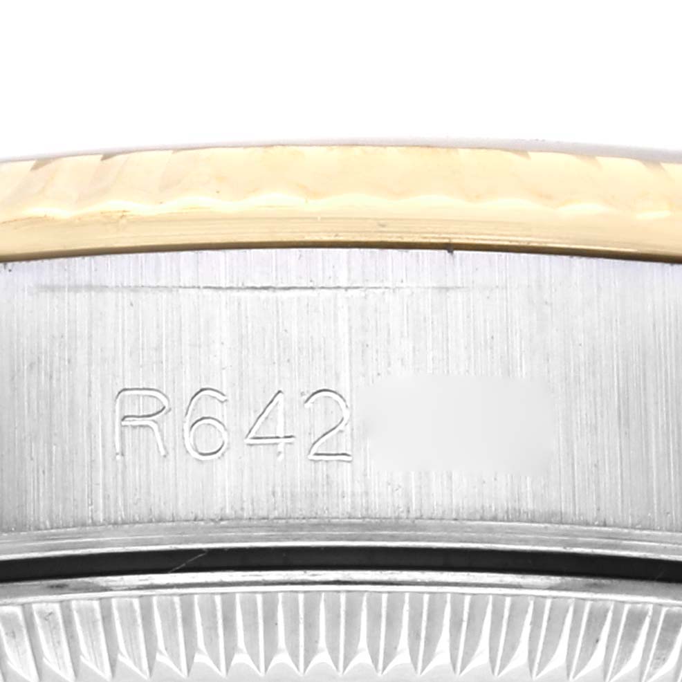 The image shows a close-up of the serial number on the side of the Rolex Oyster Perpetual 67193 Women's Steel and Gold (two tone) Champagne Dial 67193 Women's Steel and Gold (two tone) Champagne Dial watch case.