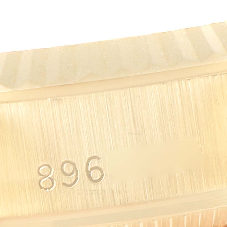 This close-up image shows the engraved serial number on the side of a Rolex President 69178 Women
s Yellow Gold Purple Dial 69178 Women
s Yellow Gold Purple Dial model watch bezel.