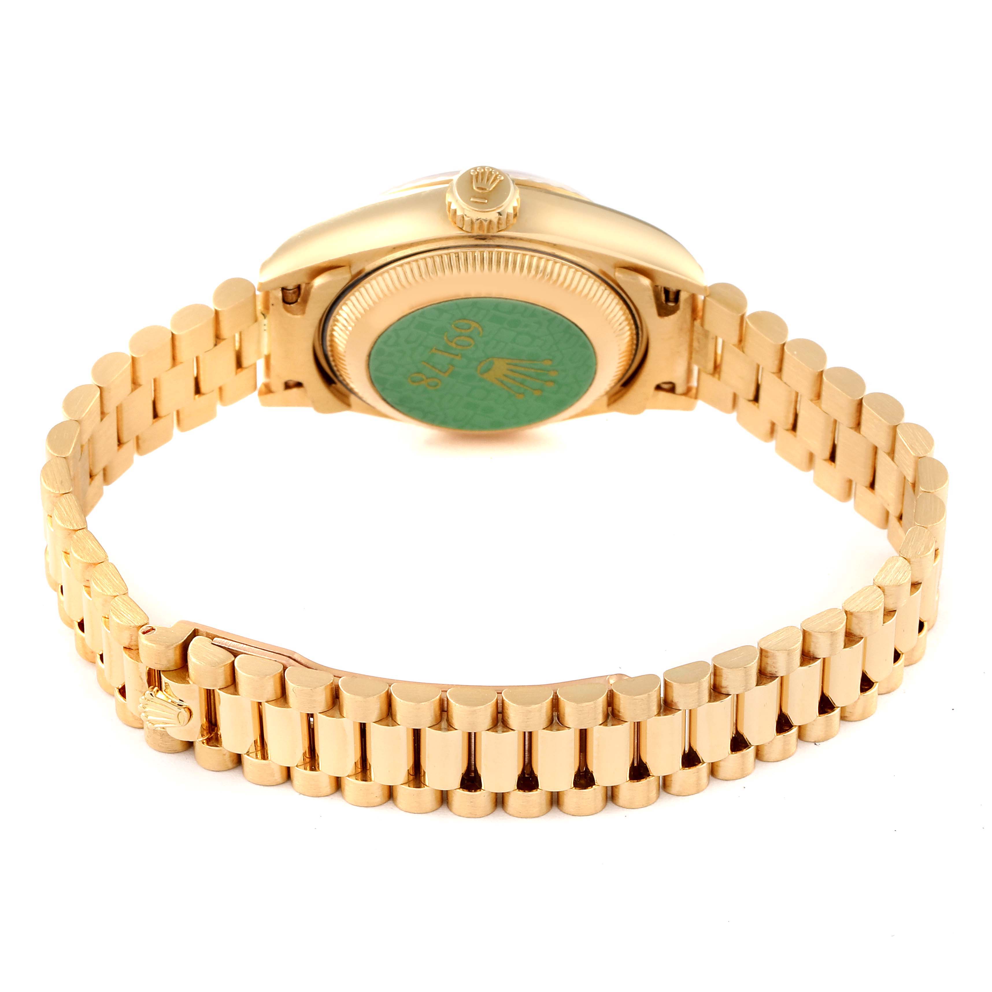 This image shows the back casing and bracelet of a Rolex President 69178 Women
s Yellow Gold Purple Dial 69178 Women
s Yellow Gold Purple Dial model watch with the crown visible on top.
