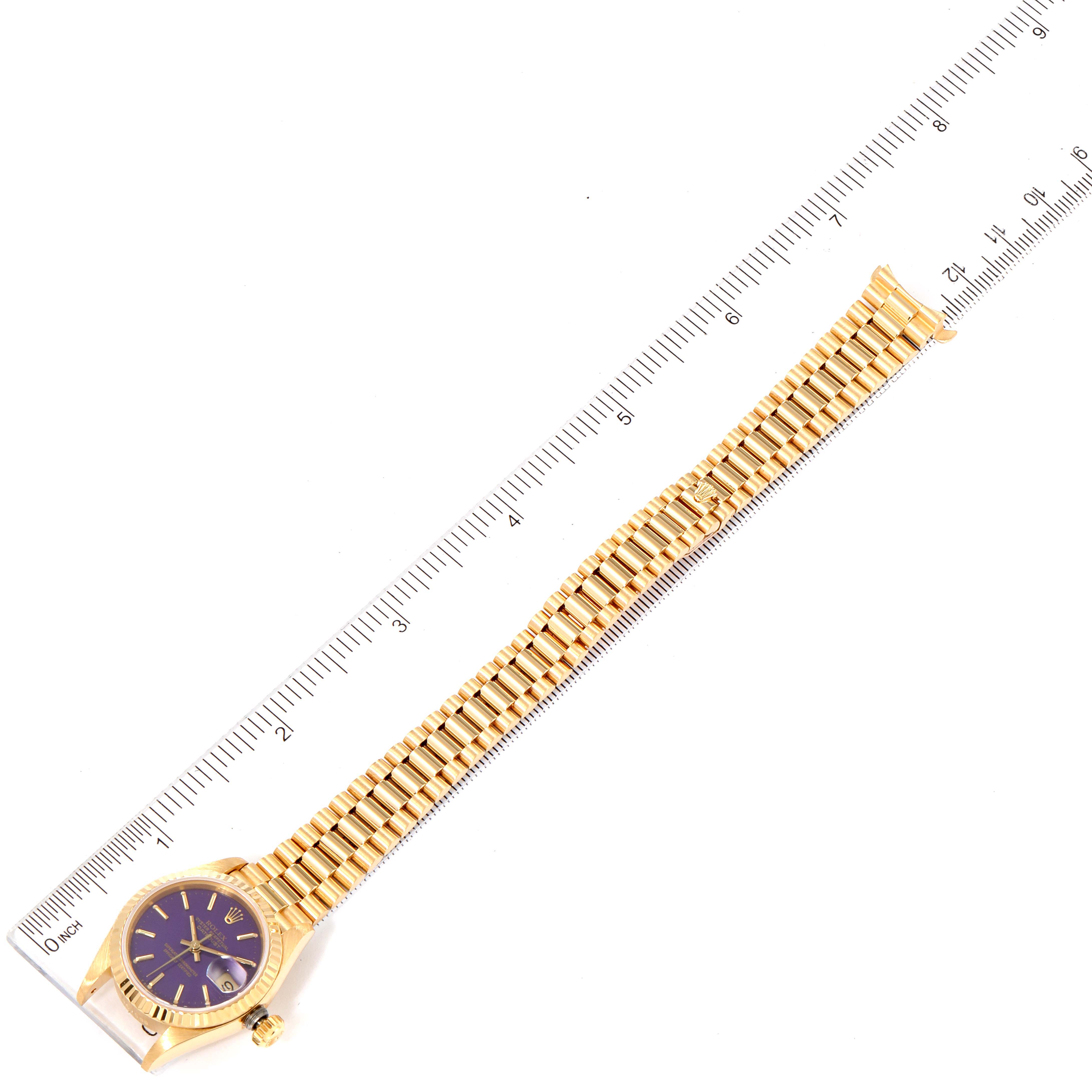 The Rolex President 69178 Women
s Yellow Gold Purple Dial 69178 Women
s Yellow Gold Purple Dial model watch is shown flat with its entire bracelet and case visible next to a measuring ruler.