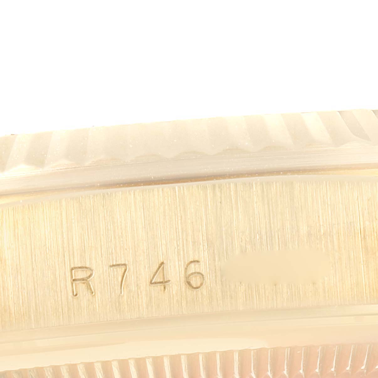 This image shows a close-up of the bezel and serial number on the side of a Rolex President 18238 Men's Yellow Gold Champagne Dial 18238 Men's Yellow Gold Champagne Dial model watch.