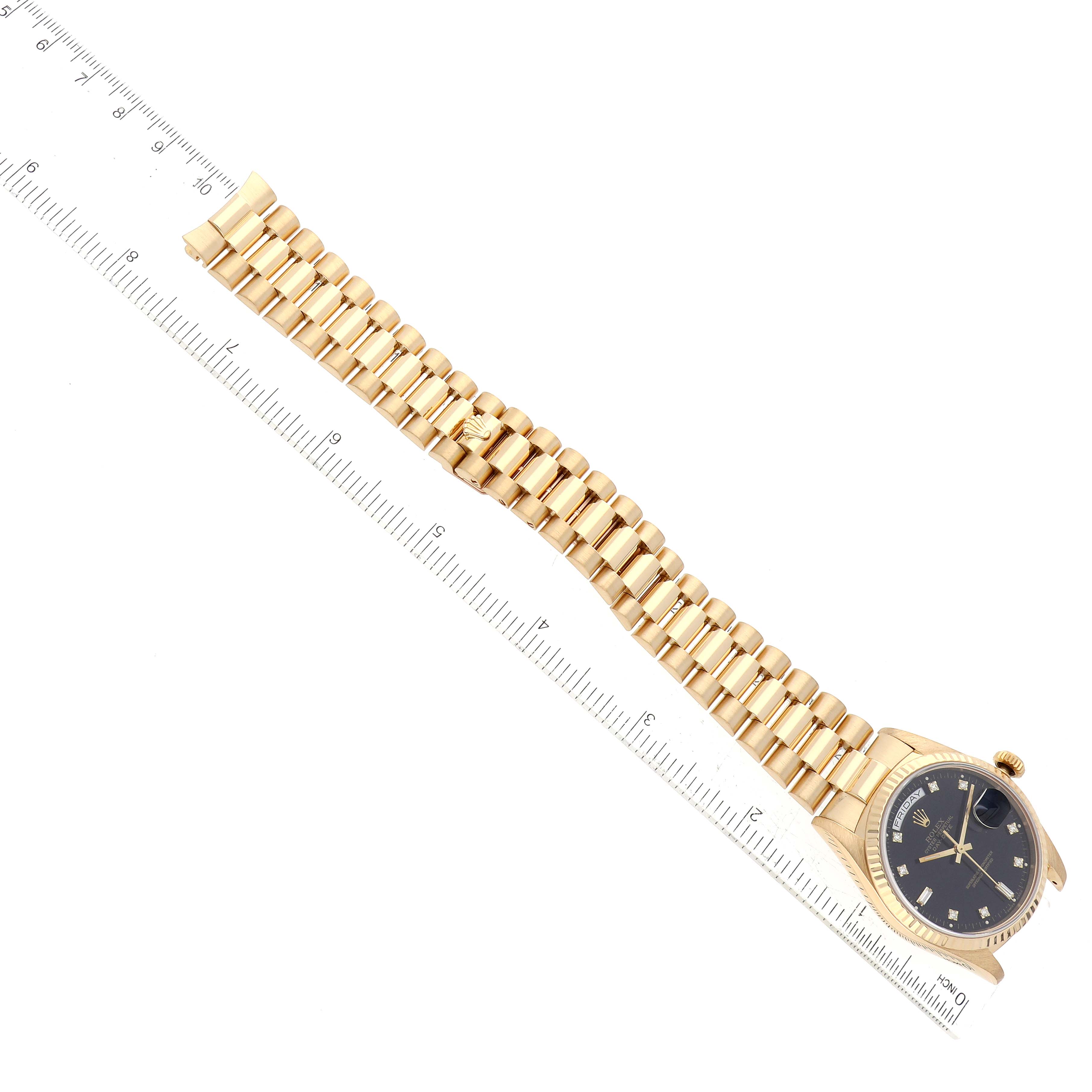 This image shows a top-down view of a Rolex President 18238 Men's Yellow Gold Black Dial 18238 Men's Yellow Gold Black Dial model watch, highlighting its gold bracelet and black dial.